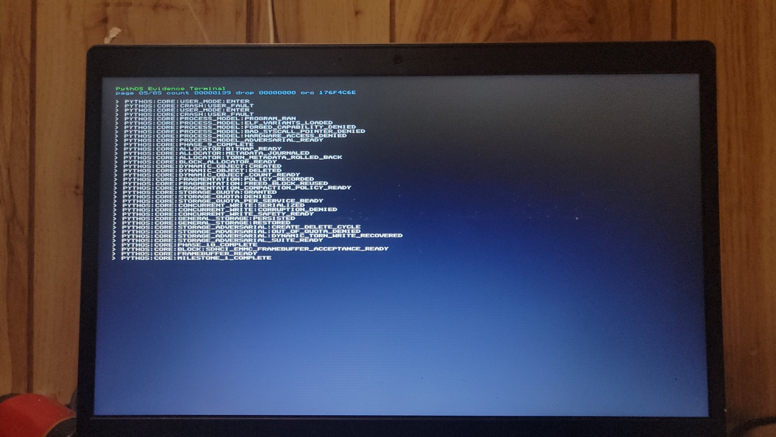 PythOS evidence terminal running on a physical laptop, with enough screen bezel visible to establish the hardware context