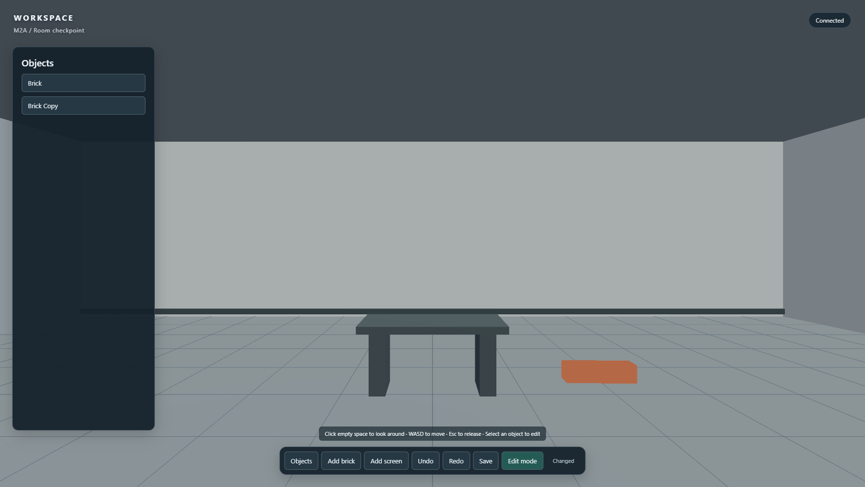 Saved M2A room checkpoint with a spatial screen placeholder, table, brick objects, object panel, trusted controls, and connected state