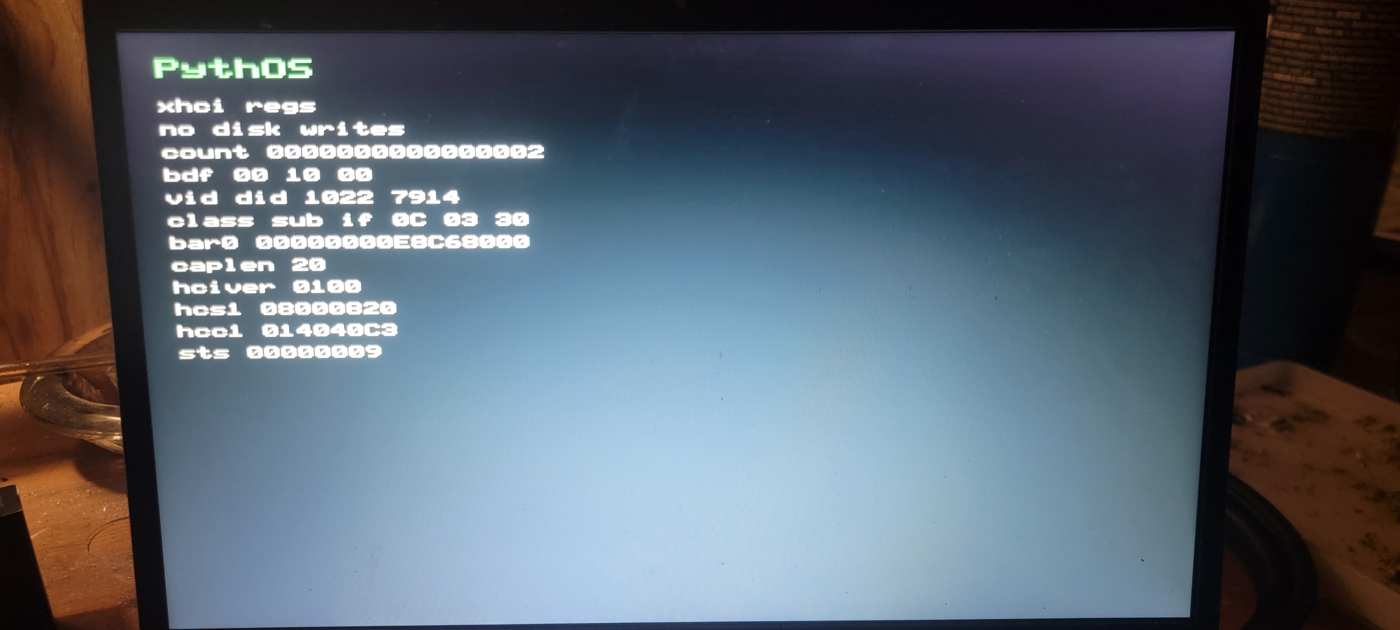 PythOS USB xHCI register probe showing AMD 1022:7914 xHCI registers and no disk writes on physical hardware