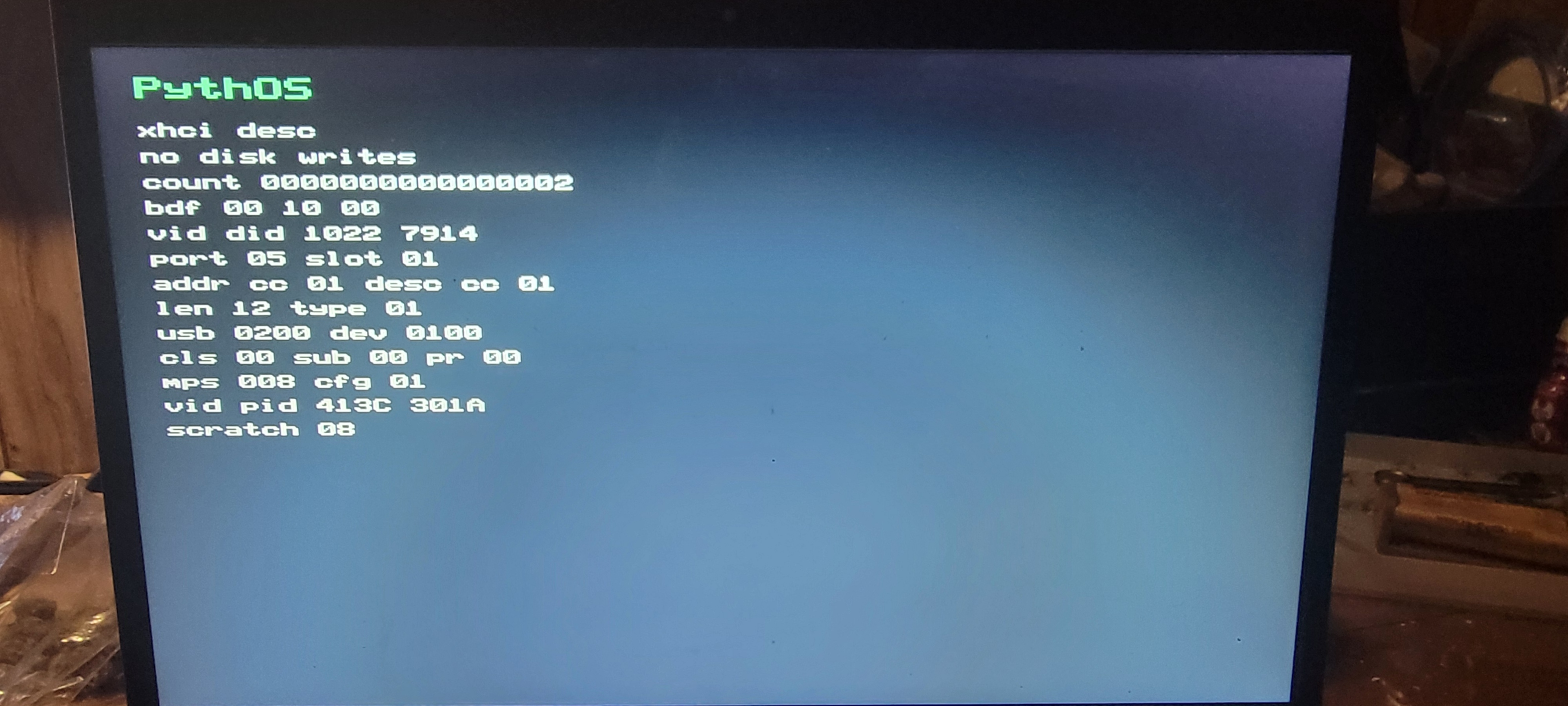PythOS USB xHCI descriptor probe showing Dell mouse device descriptor completion on physical hardware
